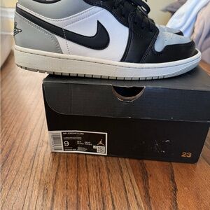 Jordan 1 lows 
Black and Gray Sneakers